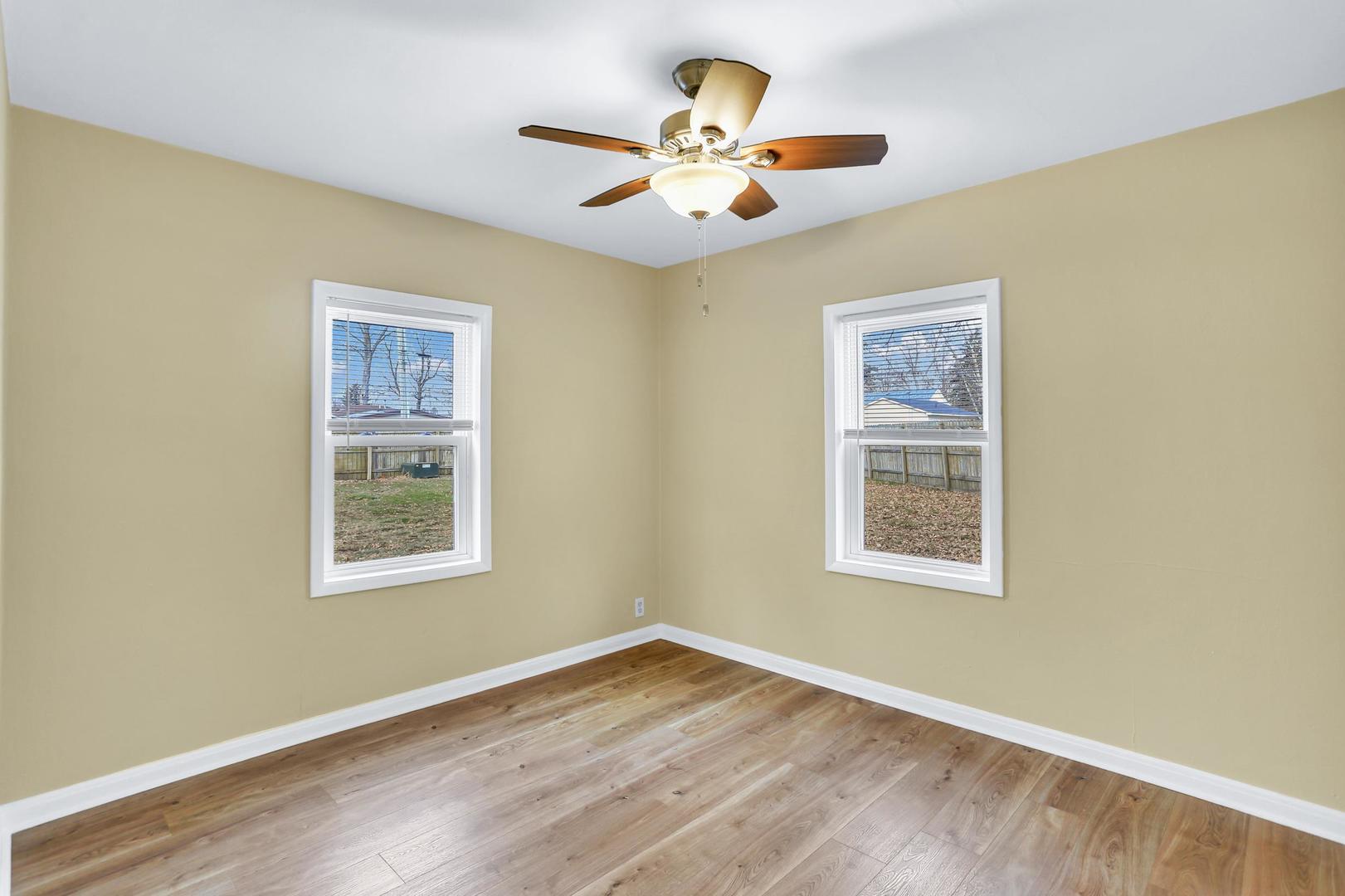 15 Gerald Road Rantoul, IL 61866 - Photo 15 of 19 a view of an empty room with a window and wooden floor