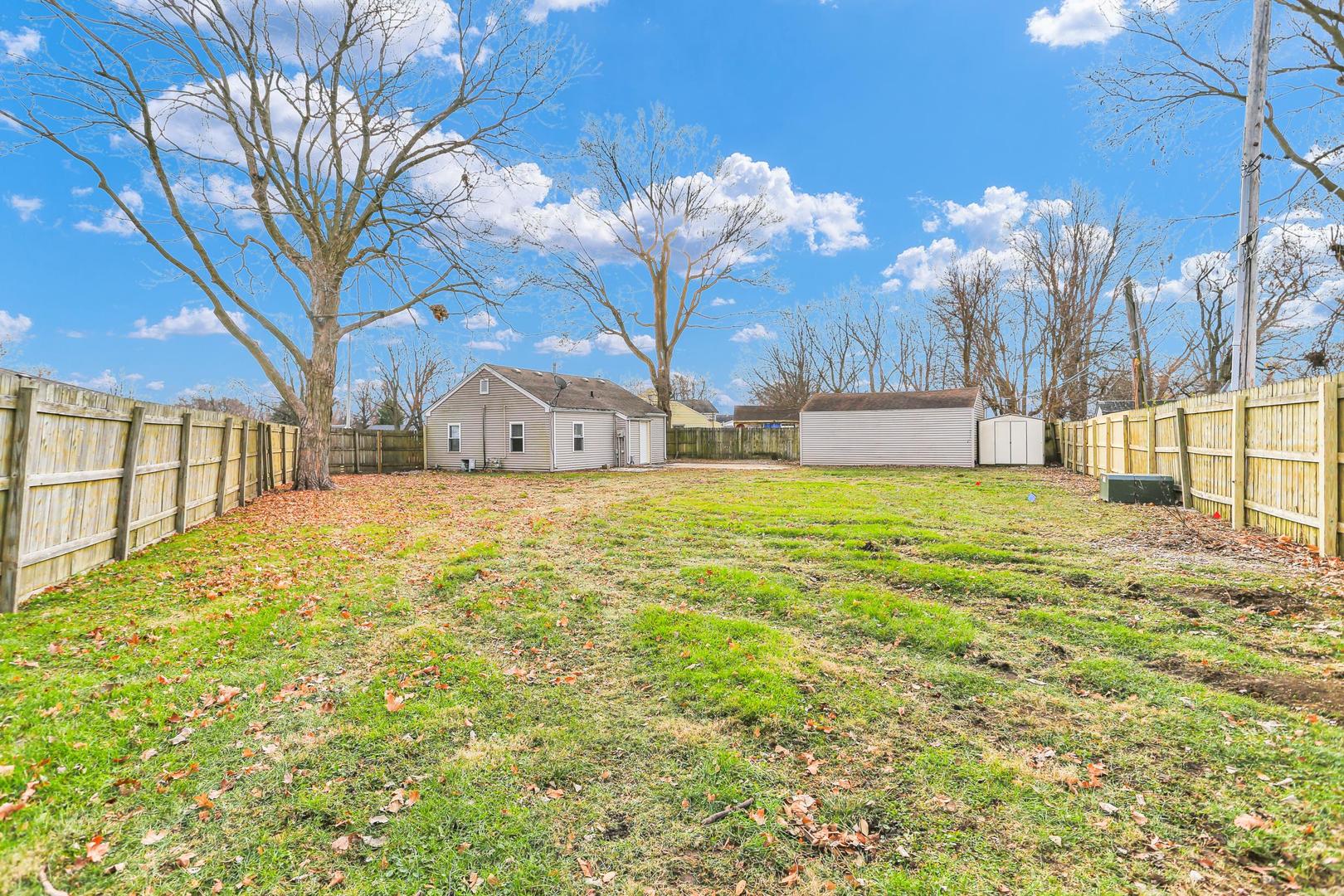 15 Gerald Road Rantoul, IL 61866 - Photo 18 of 19 a view of a yard with a house and a large tree