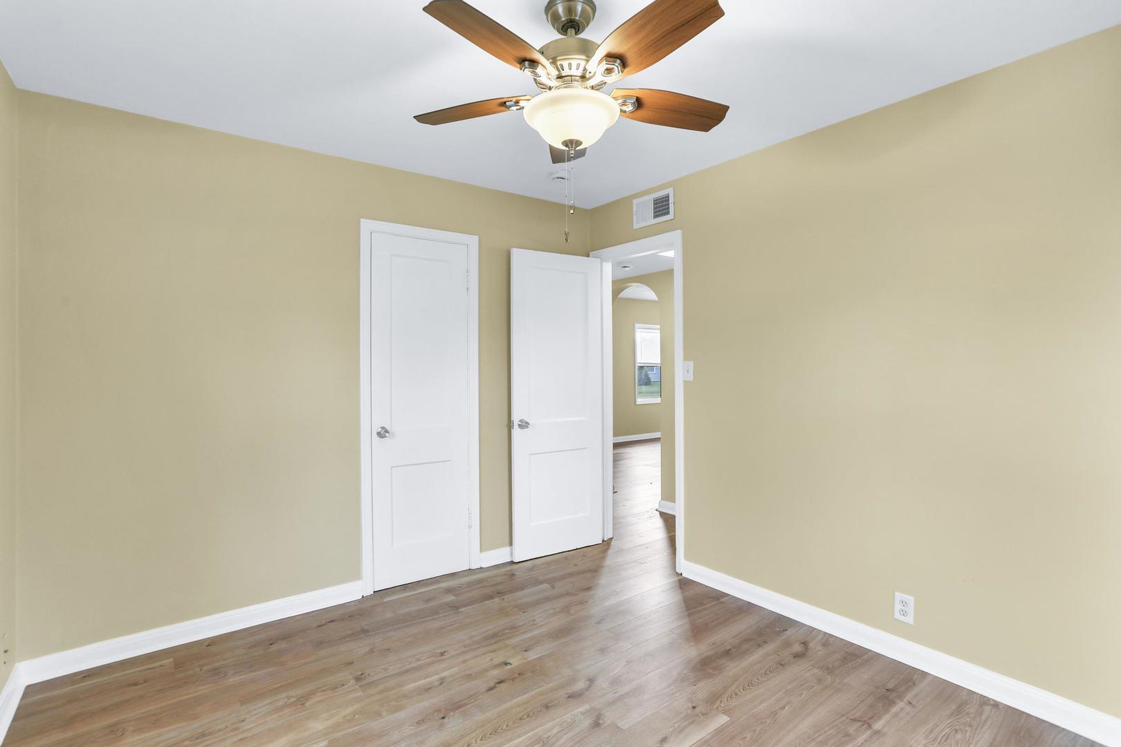 15 Gerald Road Rantoul, IL 61866 - Photo 5 of 19 an empty room with a window and a ceiling fan