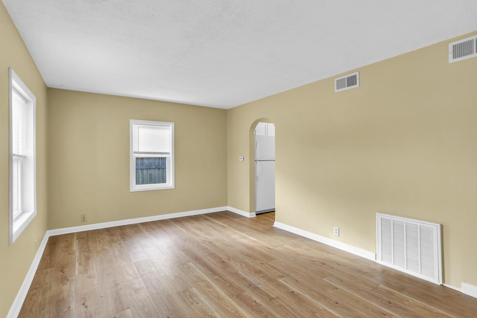 15 Gerald Road Rantoul, IL 61866 - Photo 6 of 19 an empty room with wooden floor and windows