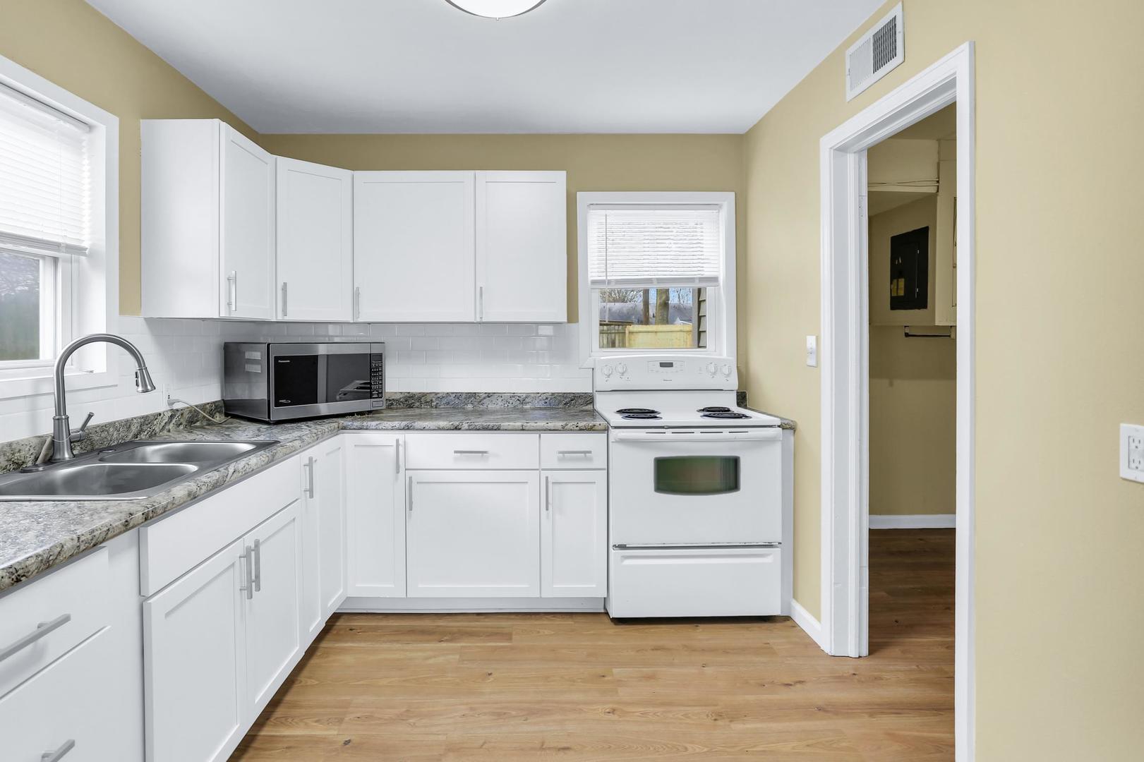15 Gerald Road Rantoul, IL 61866 - Photo 8 of 19 a white kitchen with granite top and stainless steel appliances
