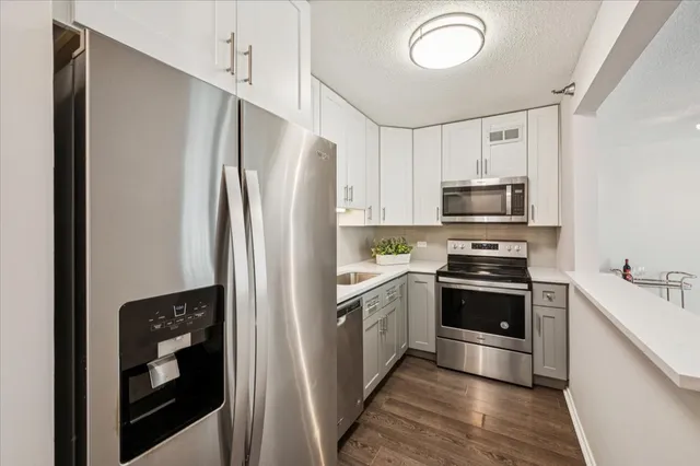 a kitchen with stainless steel appliances a refrigerator stove and sink