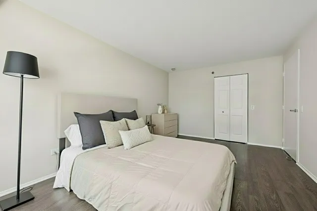 a bedroom with a bed and a lamp