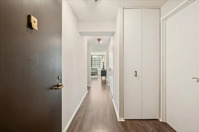 a view of a hallway with wooden floor