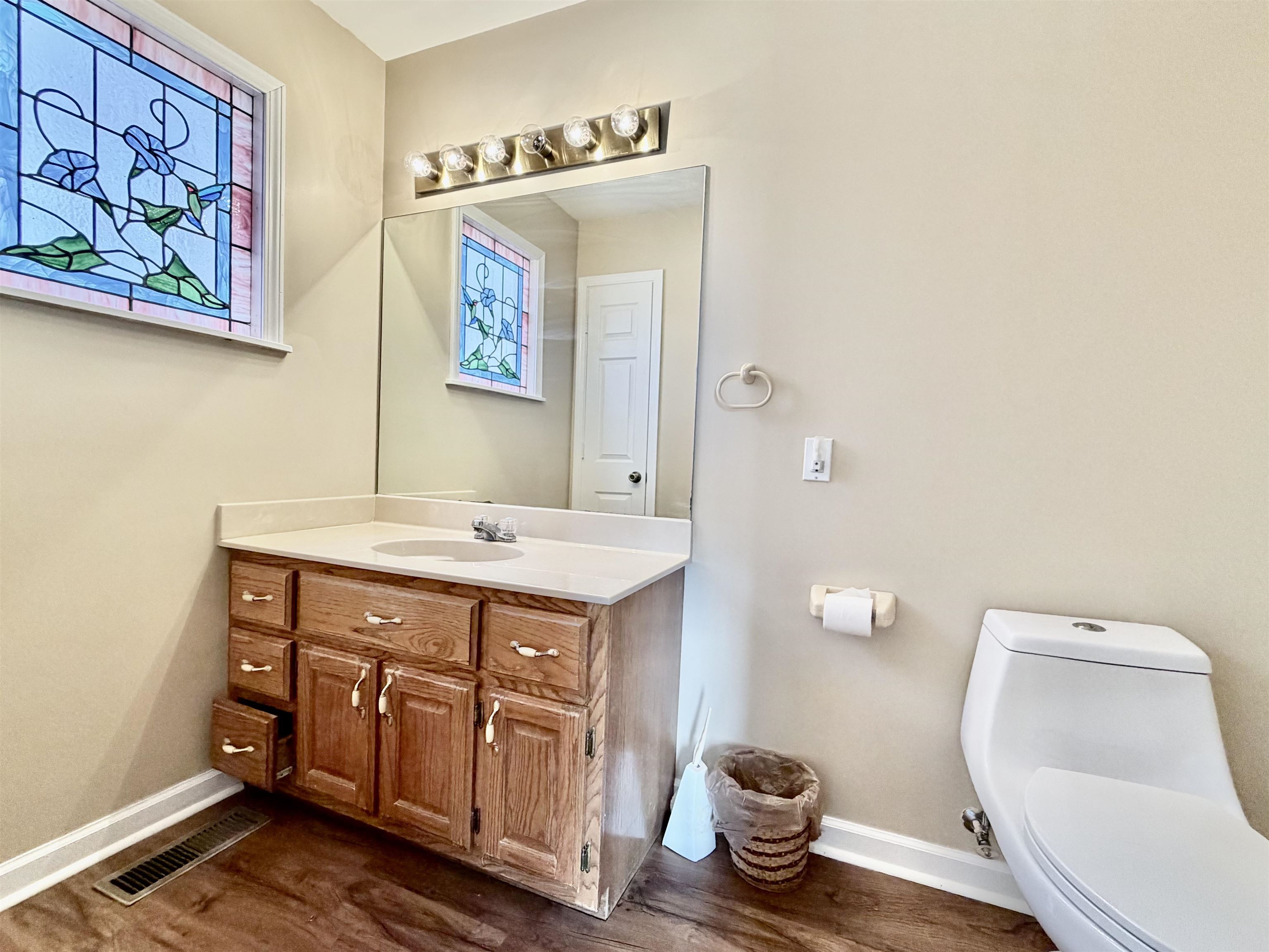 1086 Sloan Road Burlison, TN 38015 - Photo 12 of 24 Half bath with vanity and dark wood finished floors