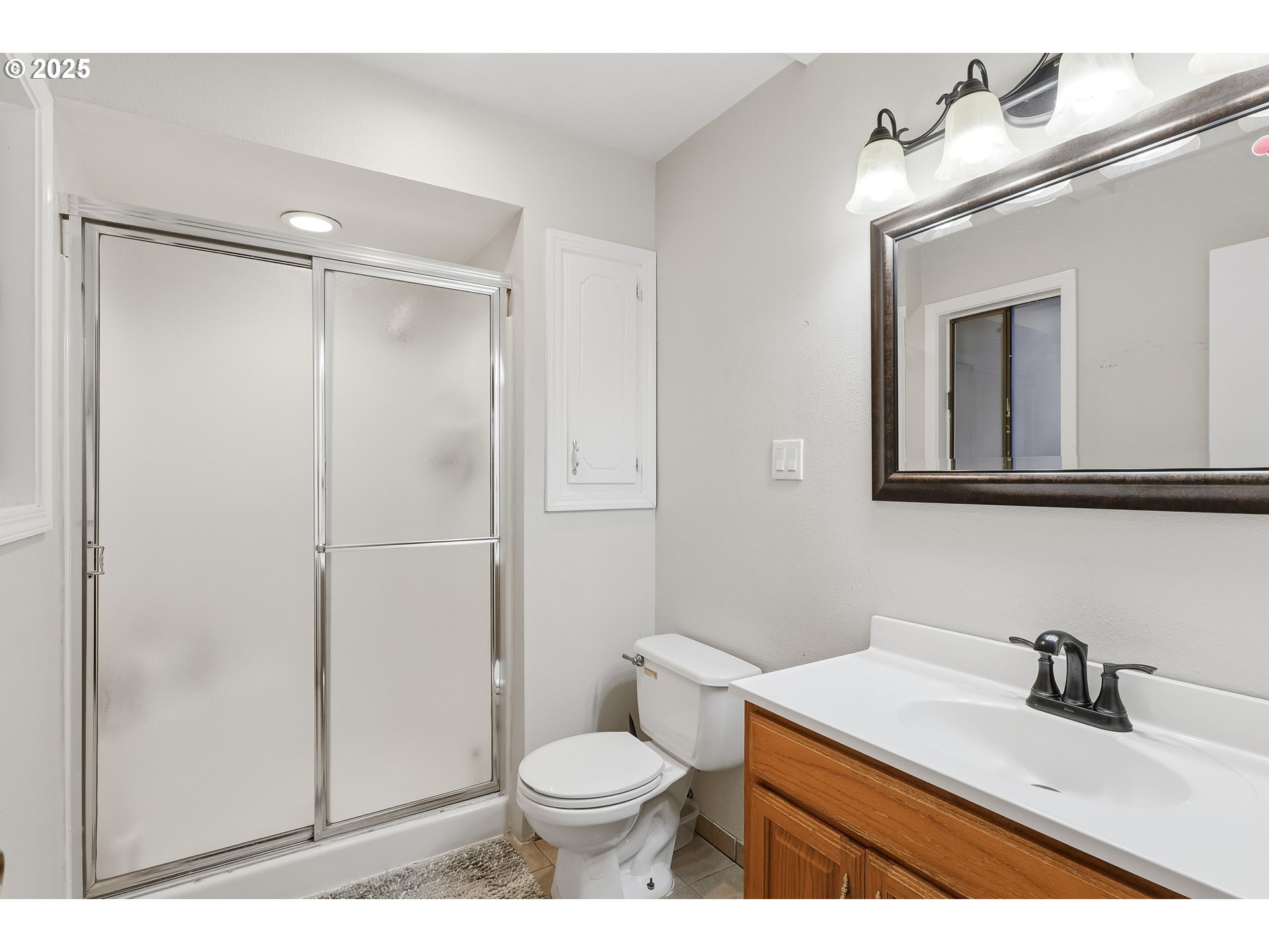 2185 Southwest 9th Court Gresham, OR 97080 - Photo 11 of 28 a bathroom with a sink toilet vanity and shower