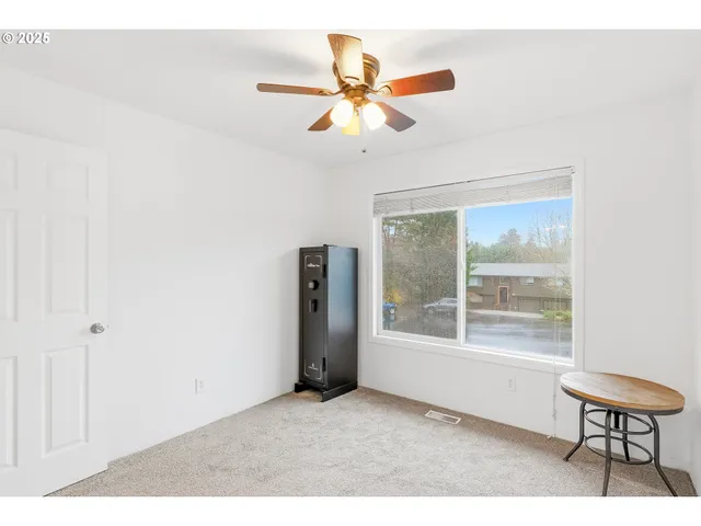 a view of a livingroom with furniture and a window