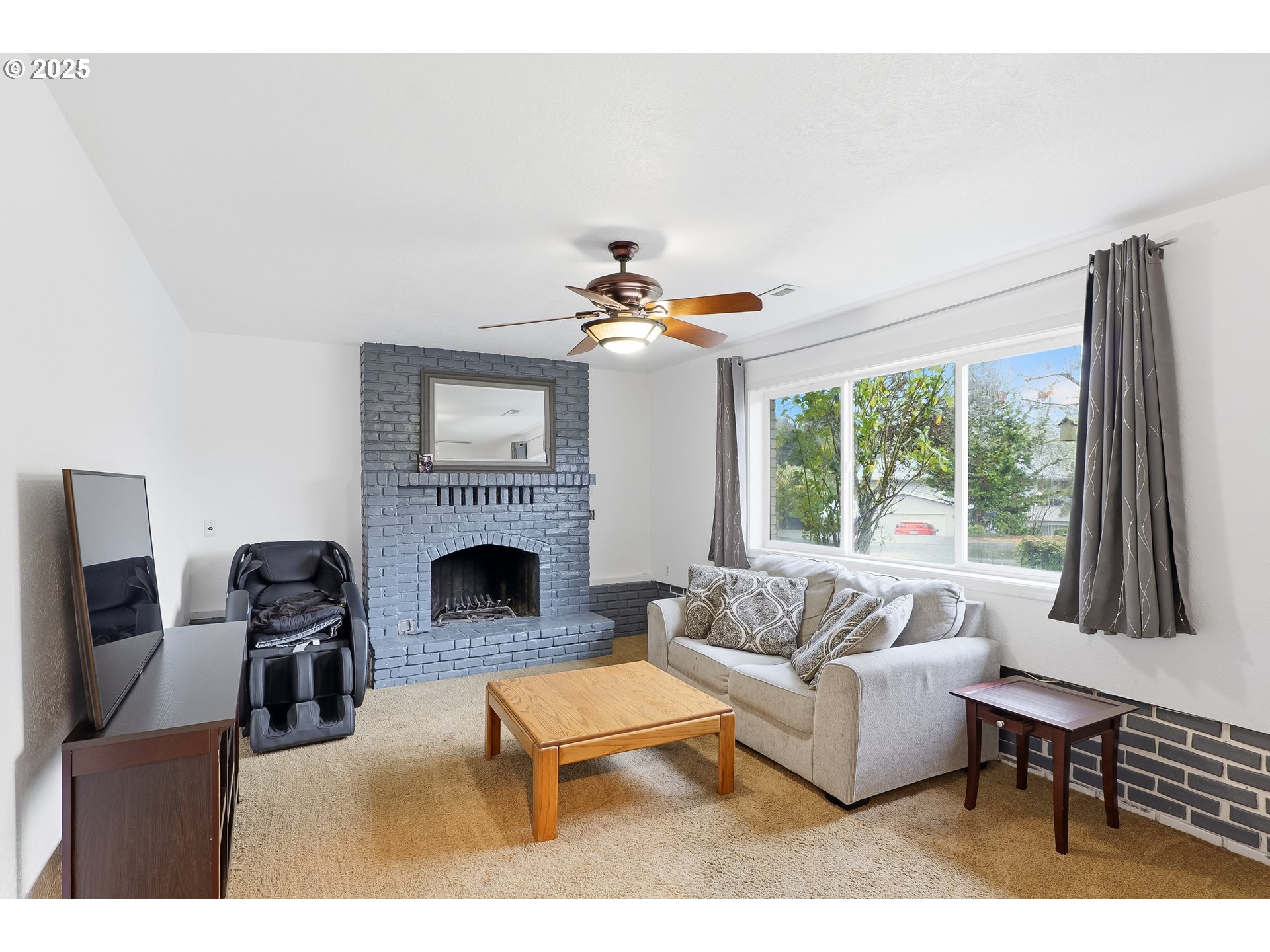 2185 Southwest 9th Court Gresham, OR 97080 - Photo 18 of 28 a living room with furniture a fireplace and a large window