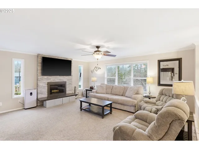 a living room with furniture a fireplace and a flat screen tv