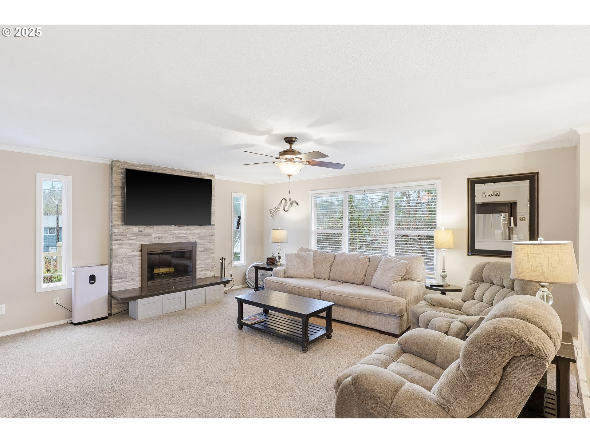 2185 Southwest 9th Court Gresham, OR 97080 - Photo 4 of 28 a living room with furniture a fireplace and a flat screen tv
