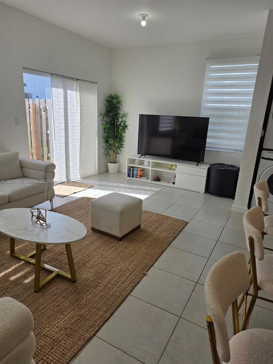 29224 Southwest 162nd Avenue Homestead, FL 33033 - Photo 15 of 26 a living room with furniture and a flat screen tv