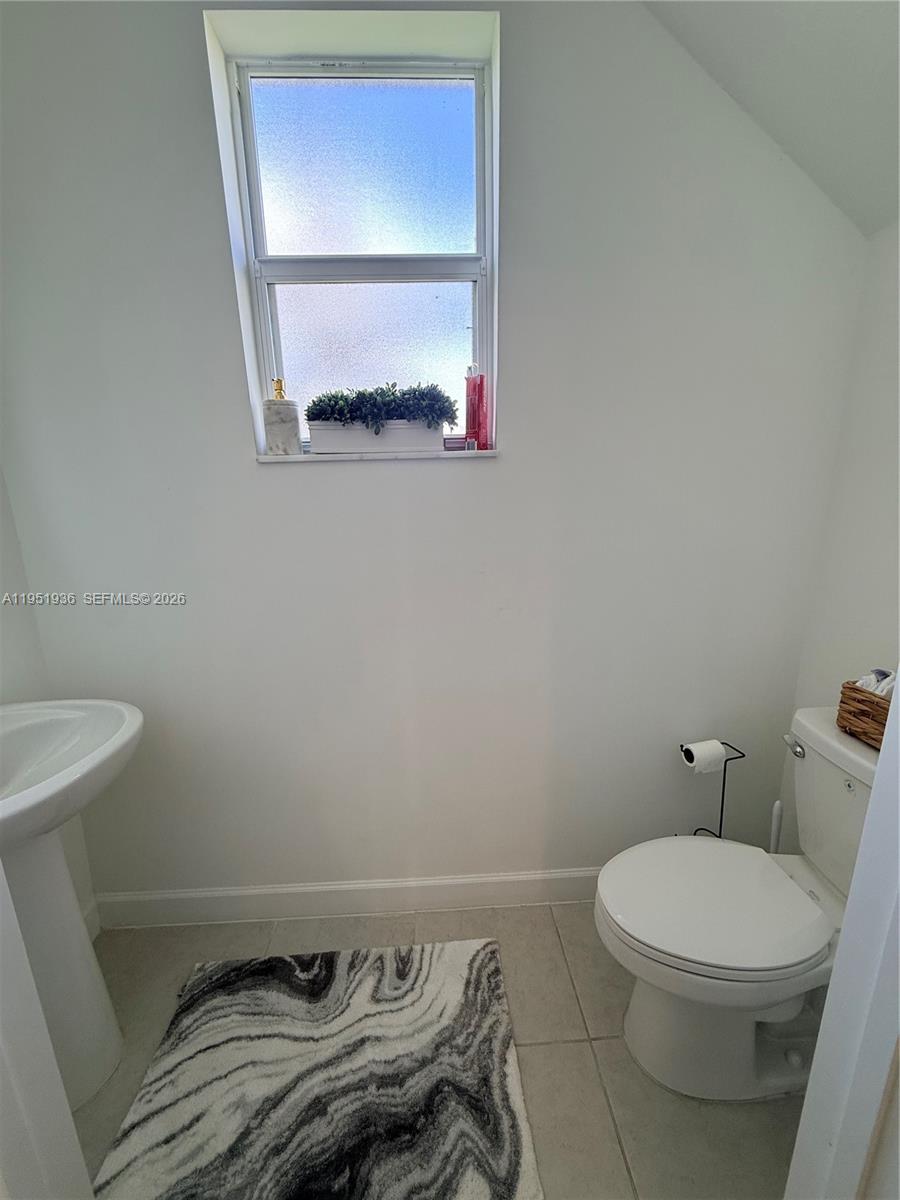 29224 Southwest 162nd Avenue Homestead, FL 33033 - Photo 17 of 26 a white toilet sitting next to a small window