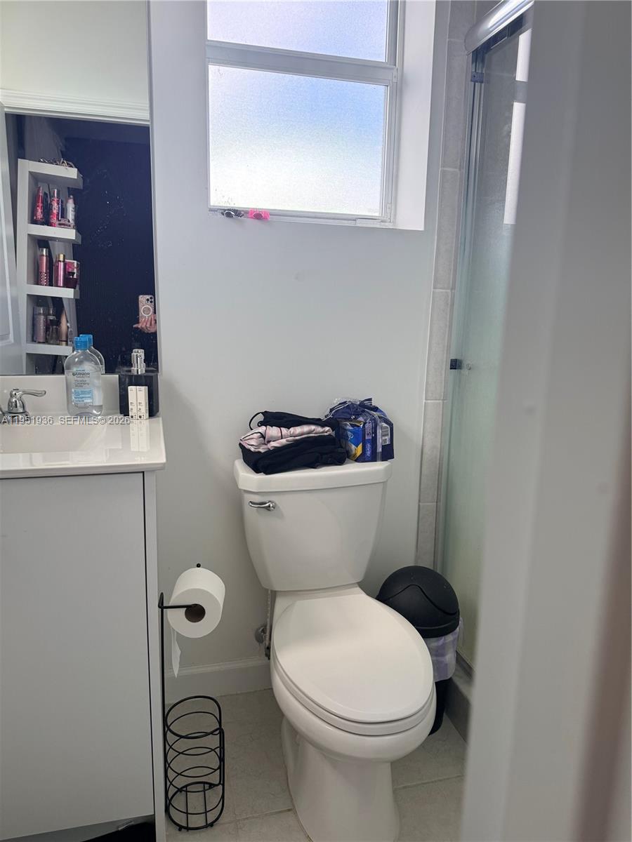 29224 Southwest 162nd Avenue Homestead, FL 33033 - Photo 22 of 26 a bathroom with a toilet sink and mirror