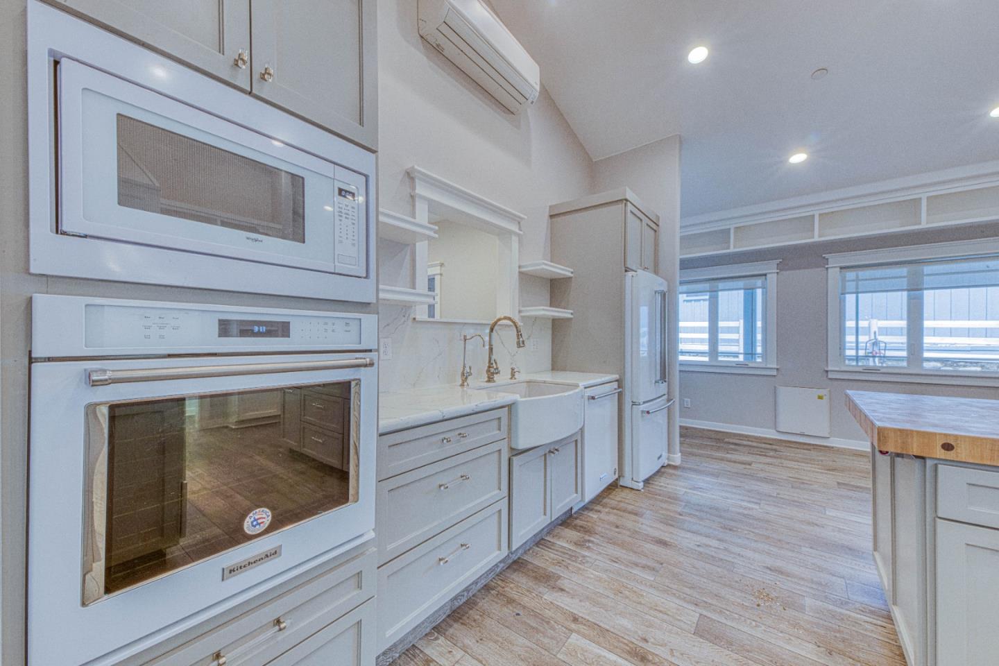 47317 Arroyo Seco Road Greenfield, CA 93927 - Photo 9 of 47 a kitchen with stainless steel appliances white cabinets and a fireplace