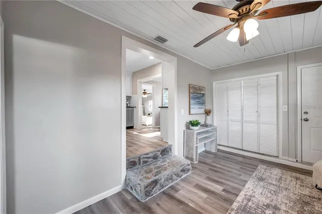 a view of a kitchen area with furniture and wooden floor