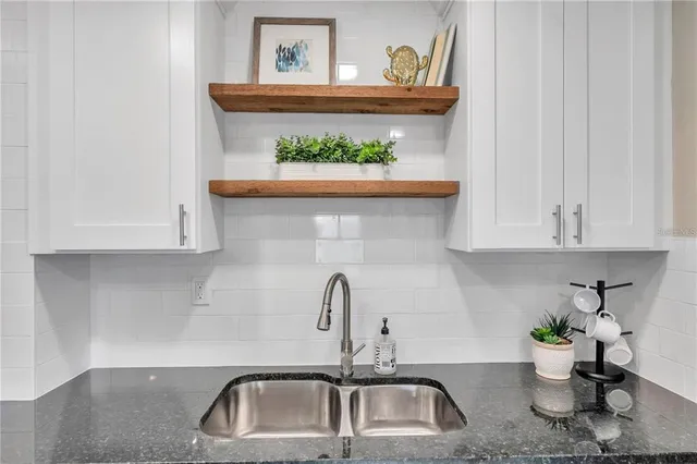 a kitchen with a refrigerator and a sink