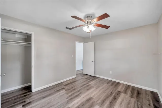 a view of backyard with tree and wooden fence