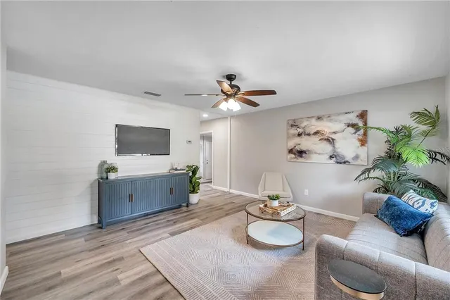 a living room with furniture and flat screen tv