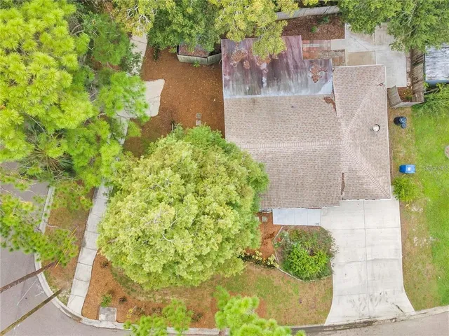an aerial view of residential building and trees around
