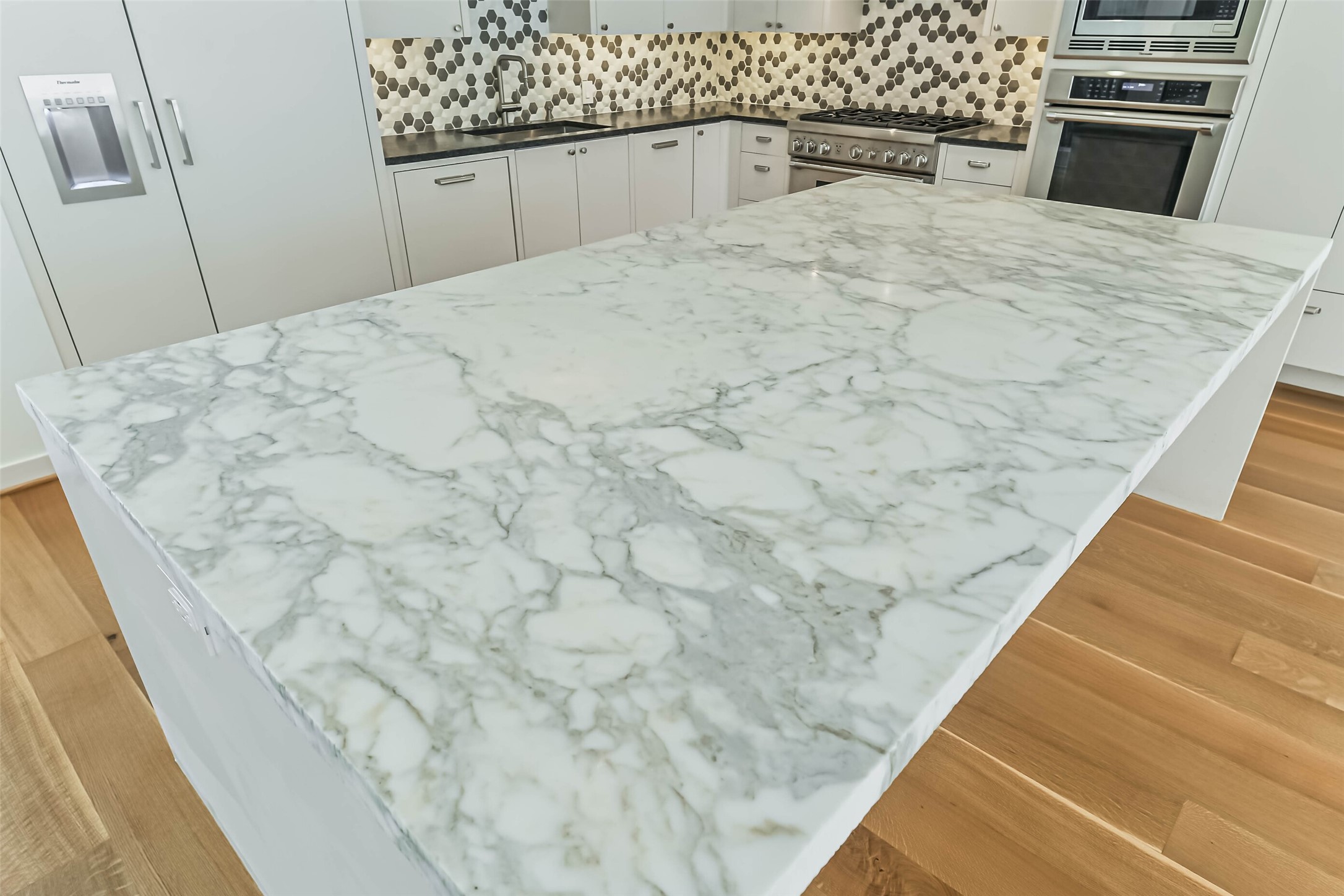815 Alexander Street Houston, TX 77007 - Photo 15 of 49 Dramatic Carrara marble island creates a stunning focal point.