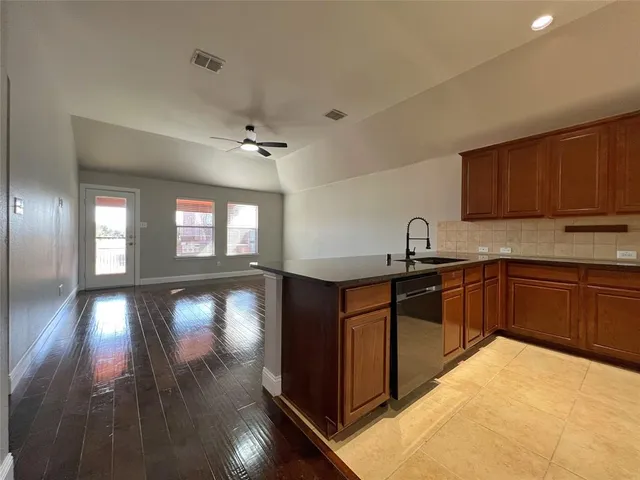 a kitchen with sink and cabinets