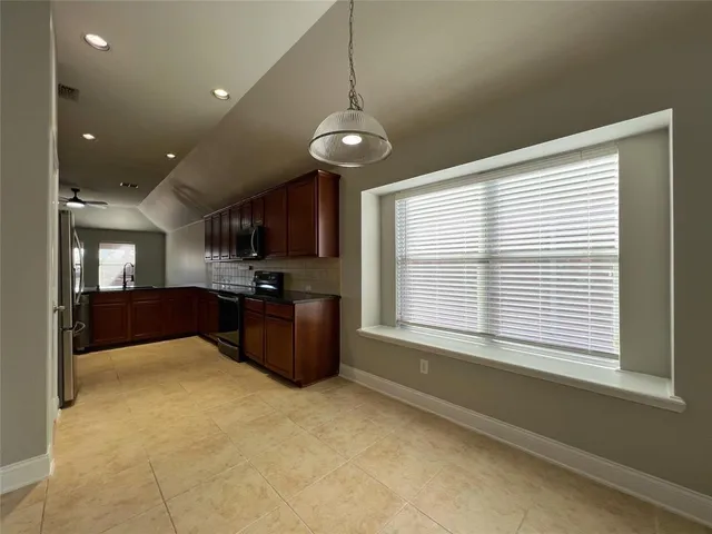 a kitchen with stainless steel appliances granite countertop a stove and a refrigerator