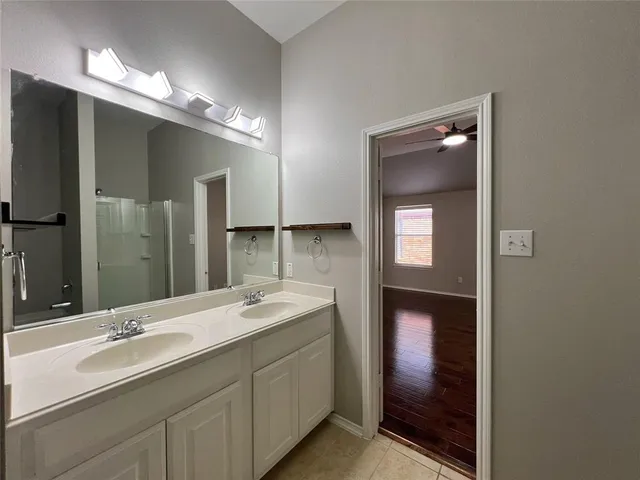 a bathroom with a double vanity sink and mirror