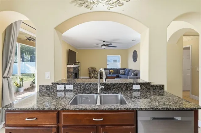 a kitchen with stainless steel appliances granite countertop a stove a sink and a refrigerator