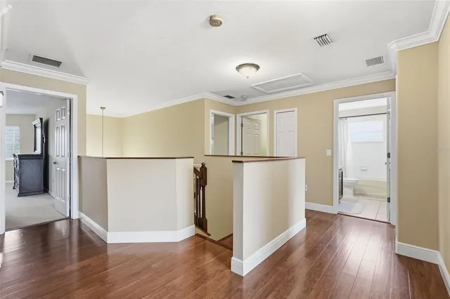 a view of a workspace with furniture and a ceiling fan