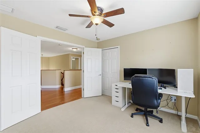 a bedroom with a bed dresser and a chandelier