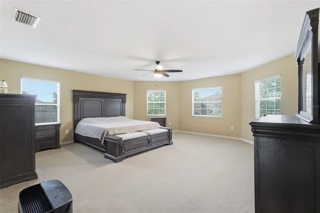 a spacious bathroom with a tub sink and mirror