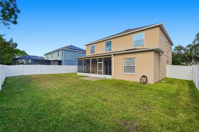 front view of a brick house with a yard