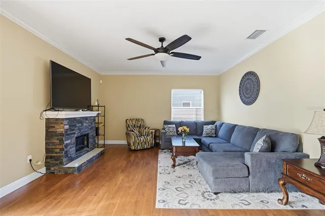 a living room with furniture a fireplace and a flat screen tv