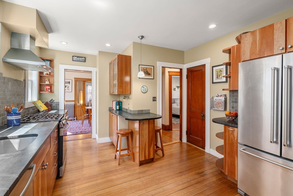 45 Springfield Street, Unit 1 Belmont, MA 02478 - Photo 12 of 27 a kitchen with stainless steel appliances granite countertop a refrigerator a stove and a wooden floors