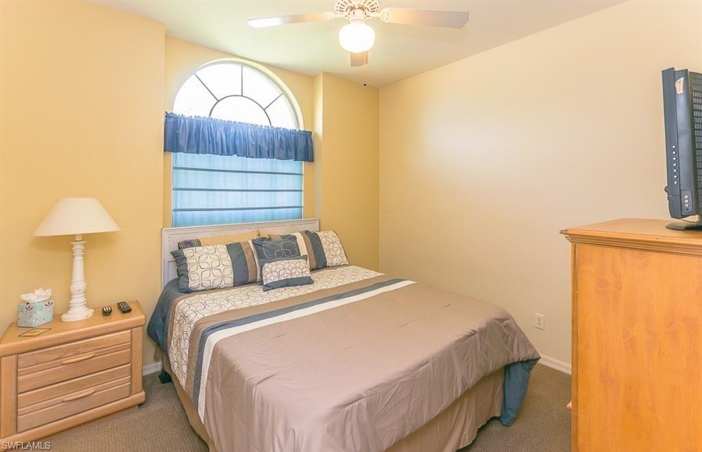 5077 Mabry Drive Naples, FL 34112 - Photo 13 of 24 a bedroom with a bed and a chandelier