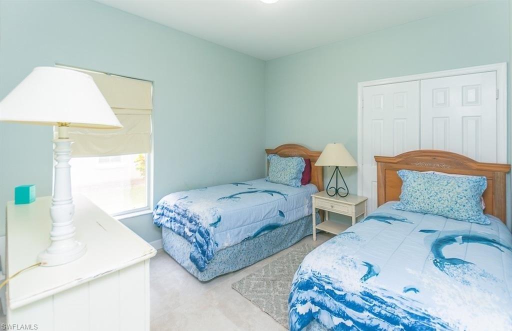 5077 Mabry Drive Naples, FL 34112 - Photo 15 of 24 a bedroom with a bed and a dresser