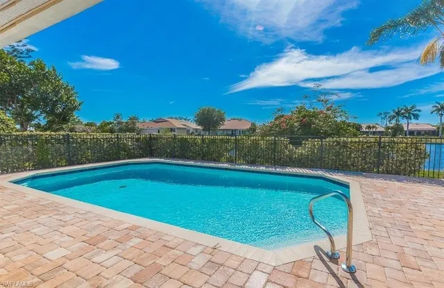 a view of a swimming pool and an outdoor seating