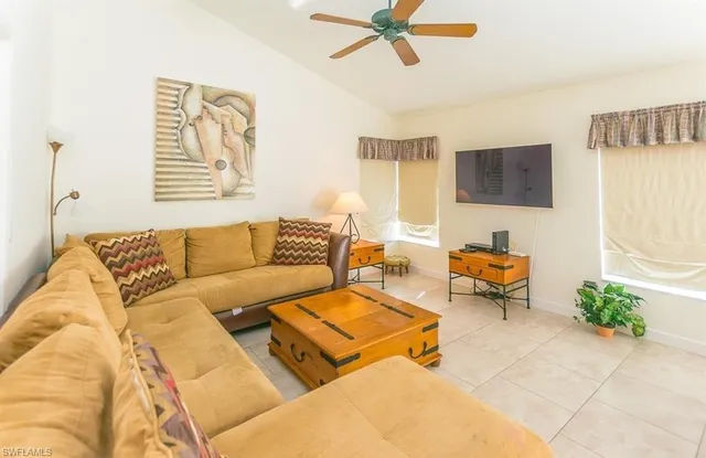 a living room with furniture and a flat screen tv