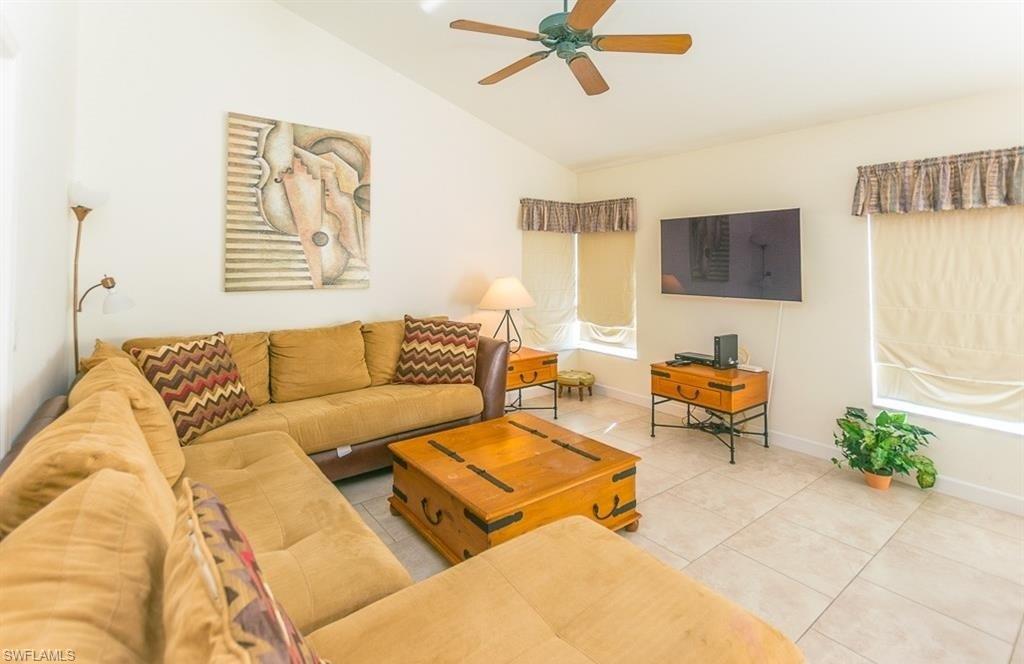 5077 Mabry Drive Naples, FL 34112 - Photo 2 of 24 a living room with furniture and a flat screen tv
