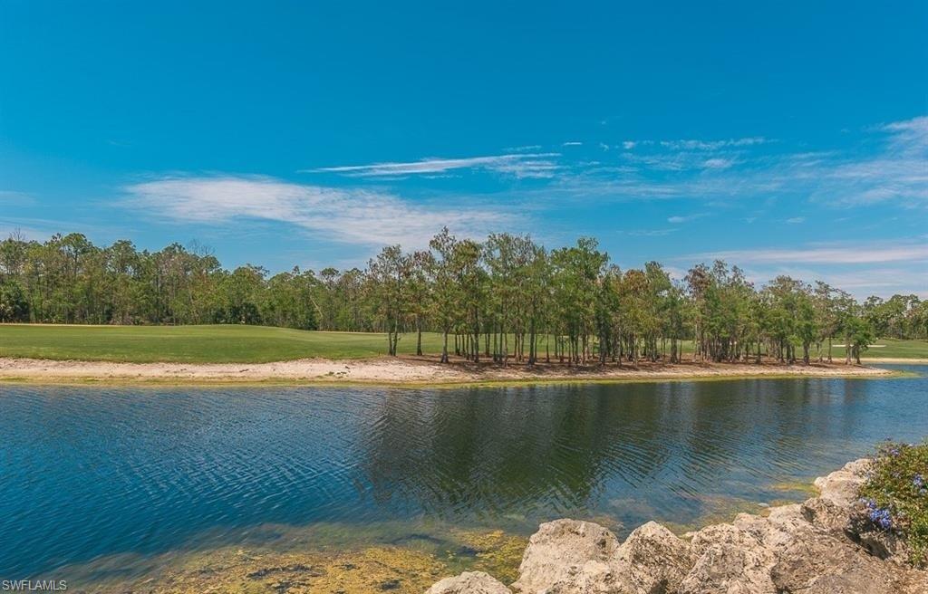 5077 Mabry Drive Naples, FL 34112 - Photo 23 of 24 a view of a lake with a city