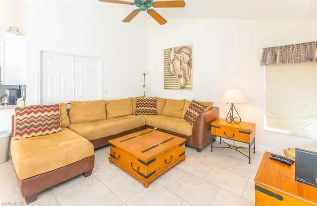 a living room with a couch and a night stand