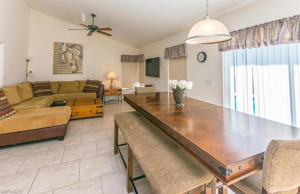 5077 Mabry Drive Naples, FL 34112 - Photo 4 of 24 a living room with furniture and a chandelier
