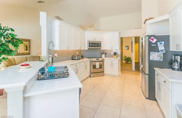 a kitchen with a stove a sink and a refrigerator