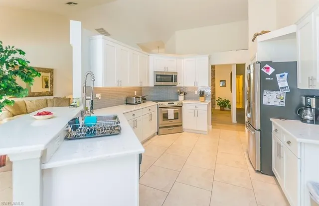 a kitchen with a stove a sink and a refrigerator