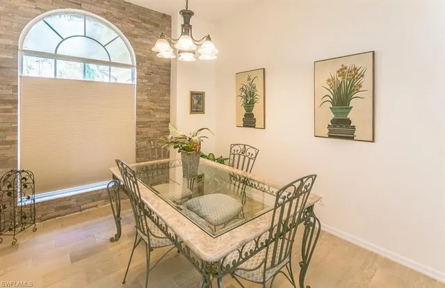 a view of a dining room with furniture and chandelier