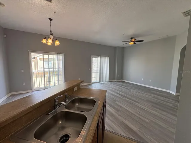 a view of a sink and dishwasher with wooden floor