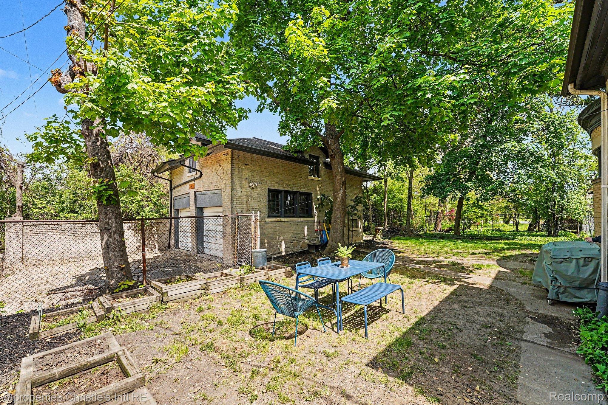 36 Longfellow Street Detroit, MI 48202 - Photo 81 of 81 Fenced backyard featuring a garage and a vegetable garden