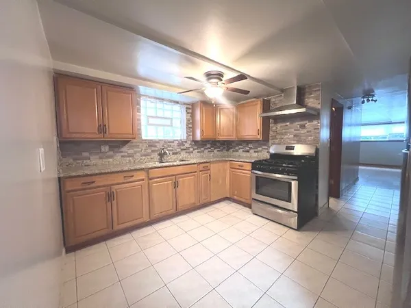 a kitchen with a refrigerator sink and cabinets