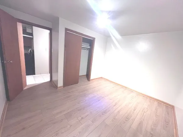 a view of an empty room and wooden floor