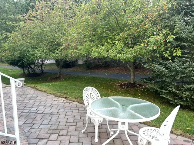 a backyard of a house with table and chairs